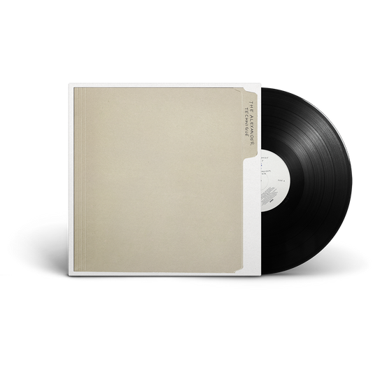 A vinyl record partially pulled from its sleeve. The sleeve is a warm beige color with a white border, and the record itself is black with a white center label.
