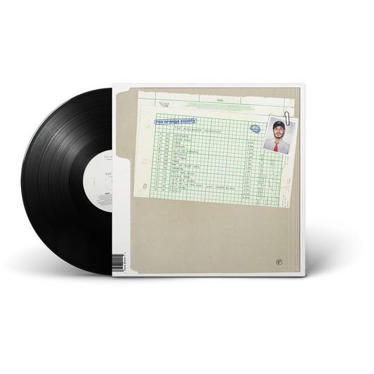 A vinyl record partially pulled from its sleeve. The sleeve features a beige cover with a green grid document and a small portrait photo in the top right corner.